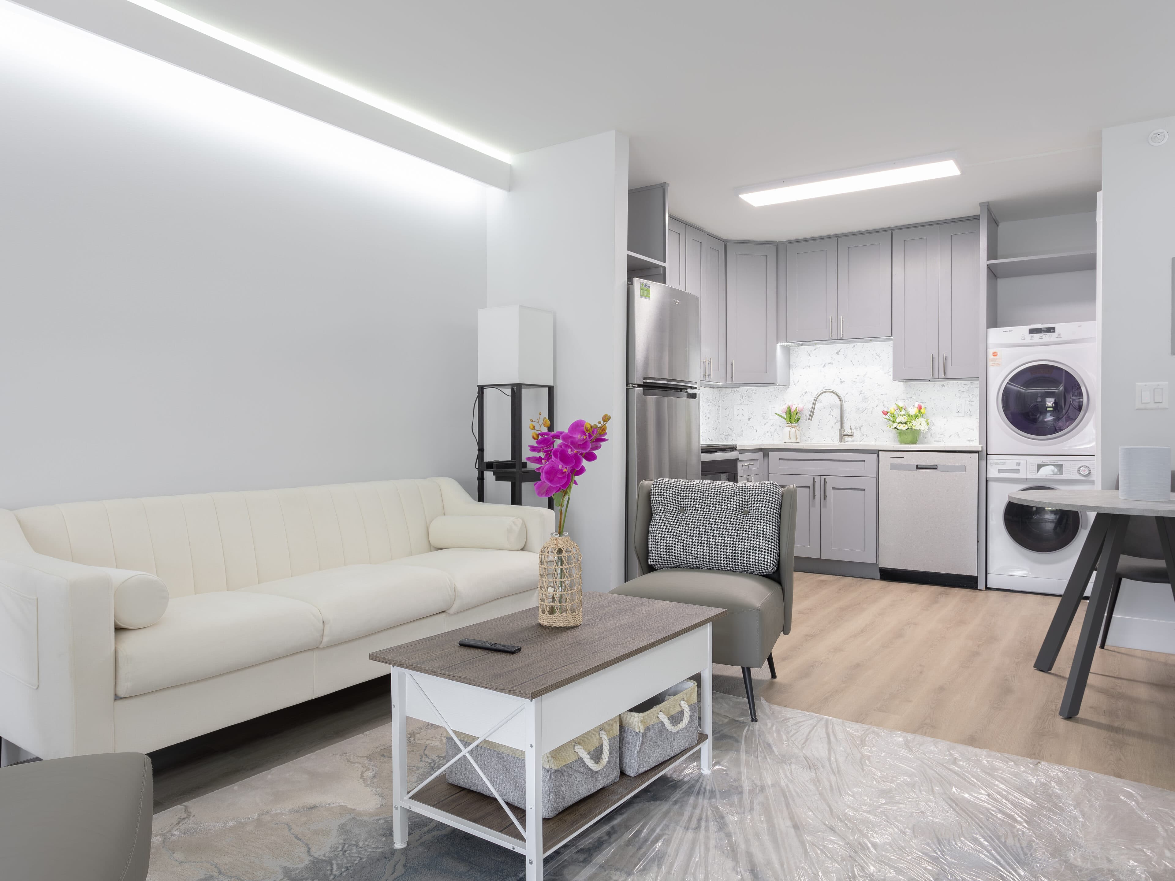 A staged apartment interior at The Jade Winter Haven after conversion: living room and kitchen